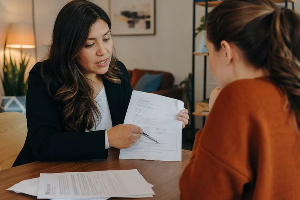 Austin Second Chance Apartments locator reviewing income documents with first time renter at Austin TX office