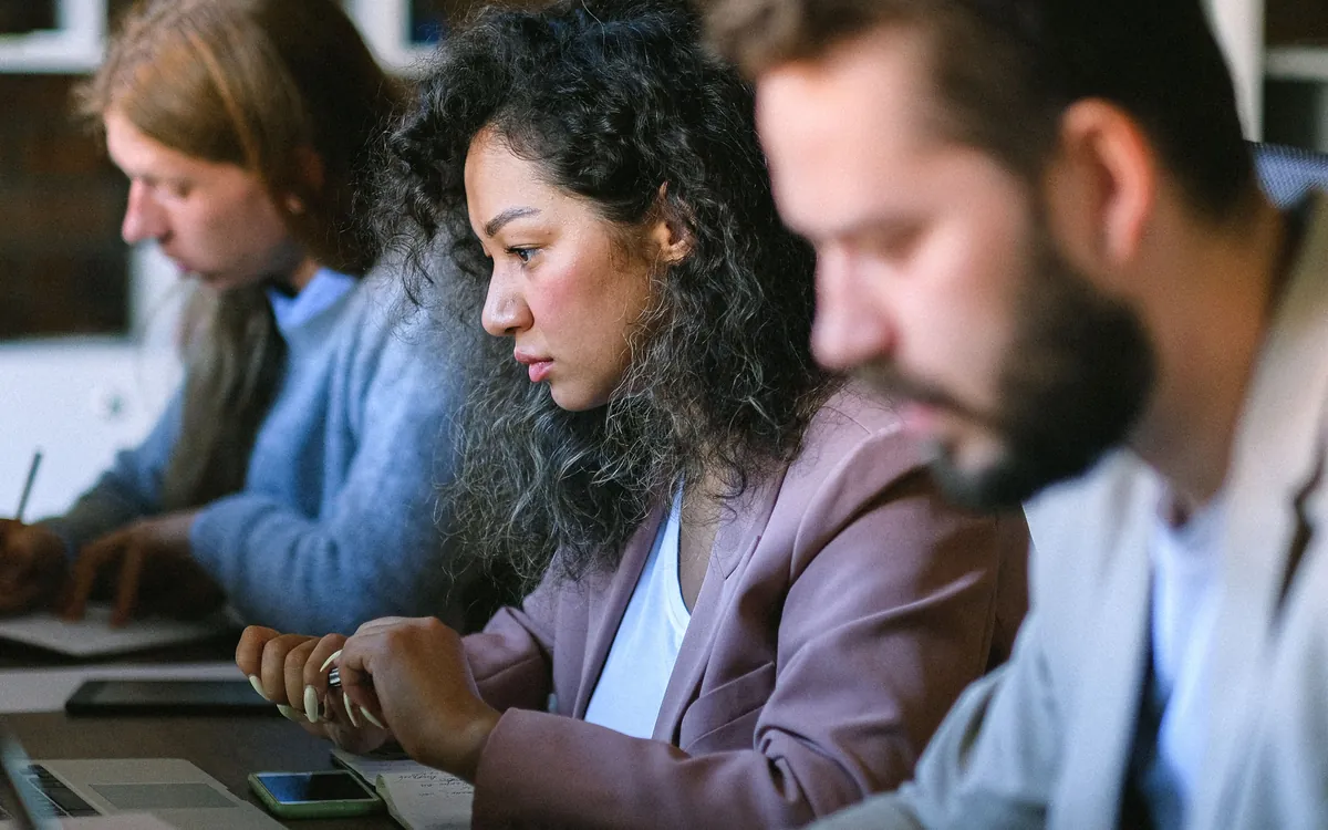 Austin apartment locator reviewing second chance apartment listings on her laptop with colleagues